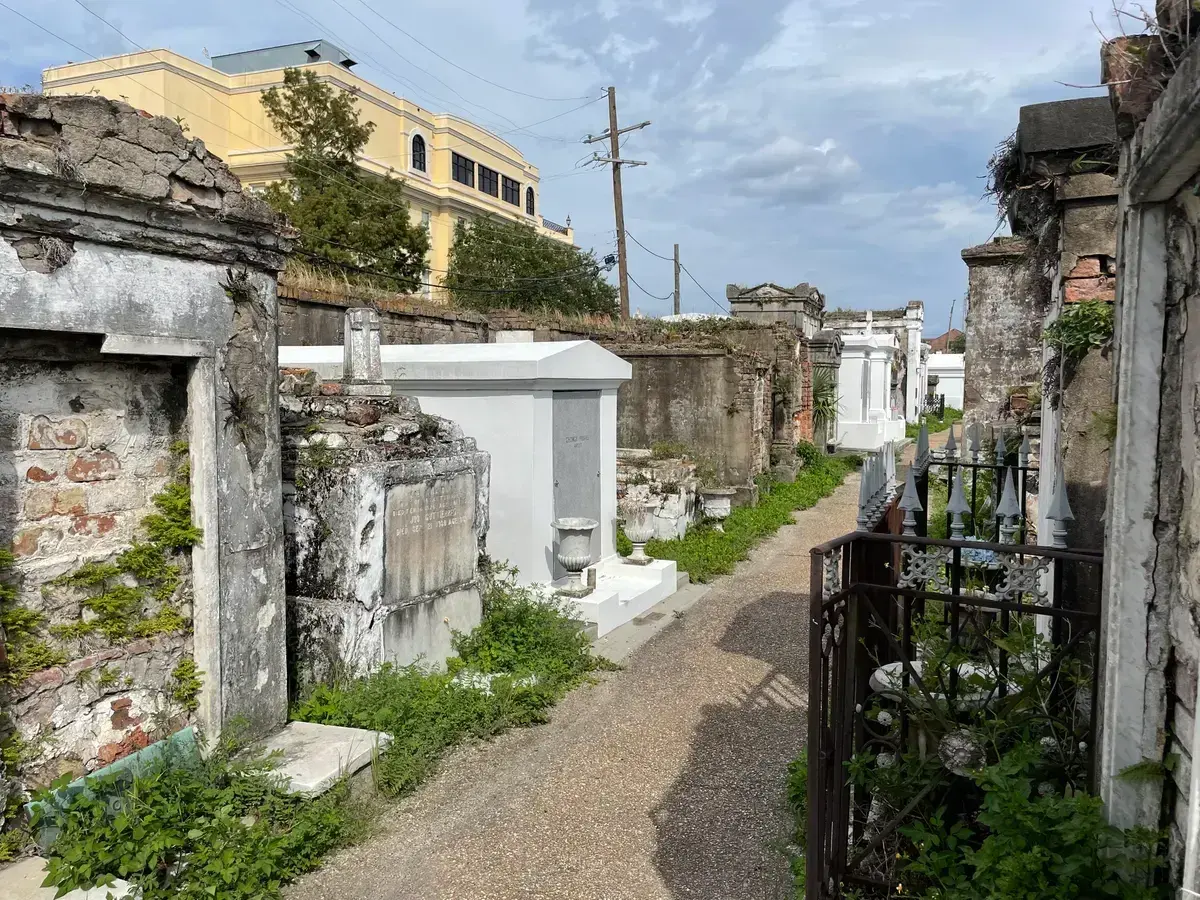 Whitewashed tombs along a path in St. Louis Cemetery No. 1, entered only on a guided tour in New Orleans